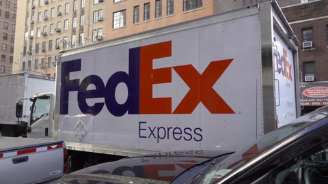FedEx truck driving on 6th Ave in Manhattan NYC