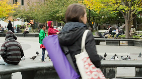 children playing with pigeons - learning tricks with birds in Washington Square Park on fall day in NYC