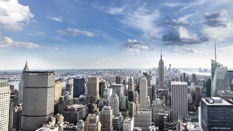 Empire State Building and MetLife skyscraper from day to night in panning timelapse - 4K Manhattan cityscape with clouds in sky overhead