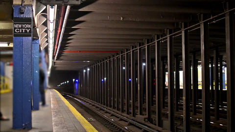 New York City sign on column in subway station platform with C train entering - with audio