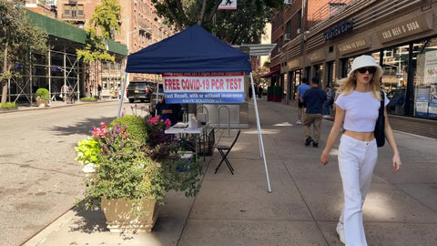 Free Covid-19 PCR test sign on medical tent setup in New York City street NYC