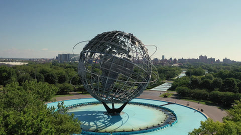 Earth globe sculpture Unisphere in Flushing Corona Park Queens pulling back aerial in New York City NYC