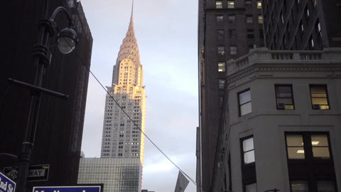 Chrysler Building street view from 42nd Street and Madison Avenue sign, tilting down to busy crowded Midtown Manhattan corner, NYC 1080 HD