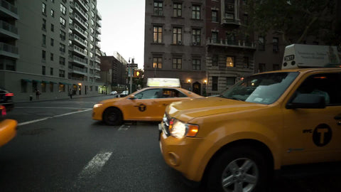 taxi cabs on Lower 5th ave on cloudy day - stationary shot in NYC
