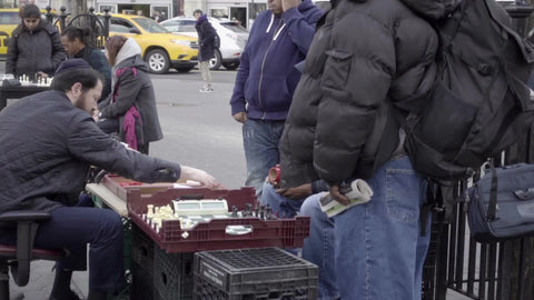 racial diversity in Union Square Park, chess matches at tables in slow motion NYC