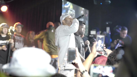 Prodigy of Mobb Deep onstage rapping at show - concert with fans holding up smartphone cameras