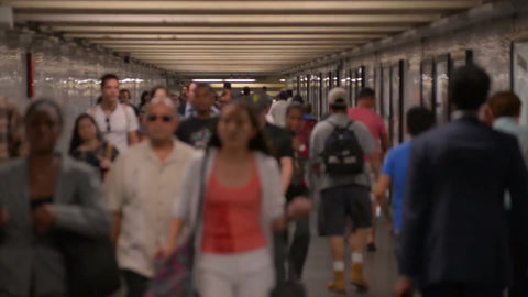 people walking in subway tunnel corridor in summer in NYC