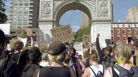 Breonna Taylor sign at BLM rally in Washington Square Park with activists holding signs in New York City