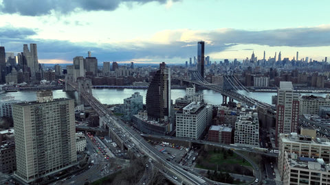 aerial panning across Manhattan skyline and two bridges Manhattan skyline from Brooklyn NYC