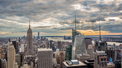 beautiful clouds passing in sky over Manhattan cityscape with Empire State Building at sunset in 4K timelapse