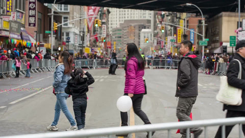 Asian-Americans crossing street in Chinatown on Chinese New Year