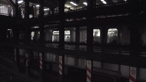 express train on middle track passing the station, people are waiting for local service on subway platform in 1080 HD in NYC