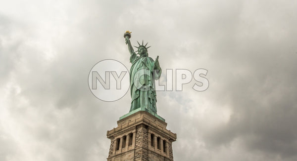 Statue of Liberty on cloudy day - far shot with full body and base