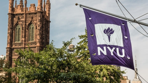 NYU flag and First Presbyterian Church on Lower 5th Ave in Manhattan on summer day