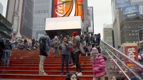 panning through busy Times Square crowded with people - tourists visiting New York City on cold winter day in 4K